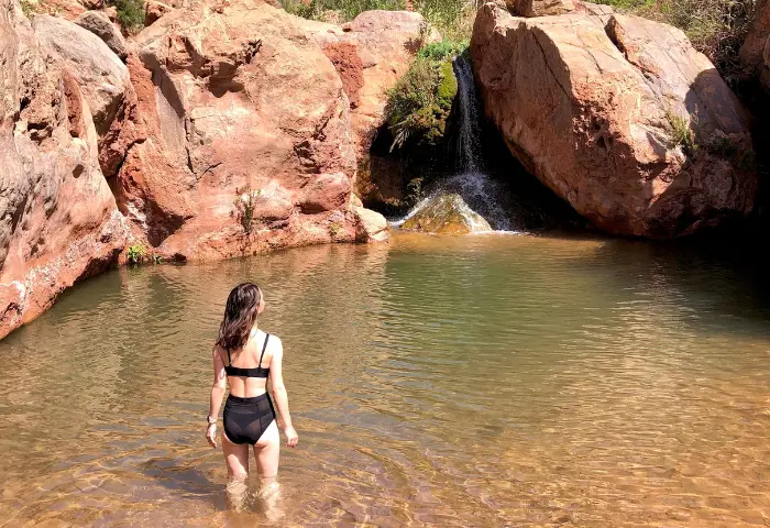 Hiking through the hidden Paradise Valley near Agadir, surrounded by palm trees, rock pools, and mountains